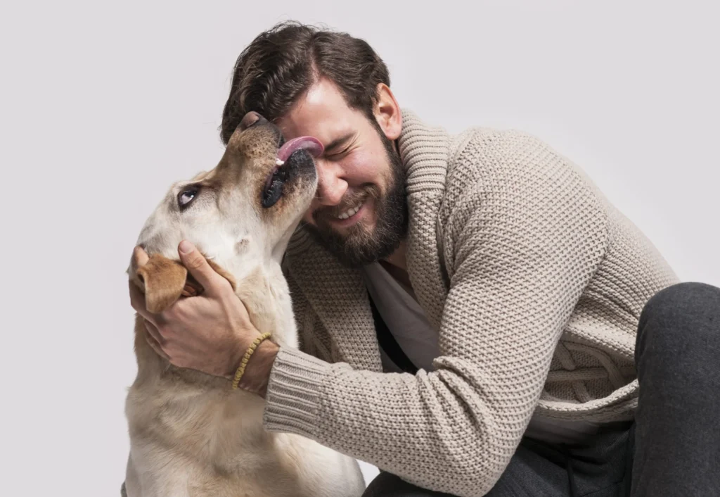 dog licking a guy