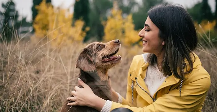 owner and dog in the field